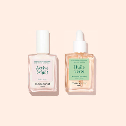 Two clear manicure bottles from Manucurist’s "Basic Routine - Yellow Nails" on a pale background: one labeled Active Bright with a white cap, expertly formulated for nail brightening, and the other, Huile Verte with a dropper, ideal as nourishing cuticle oil. Both products offer essential nail care solutions from Manucurist.