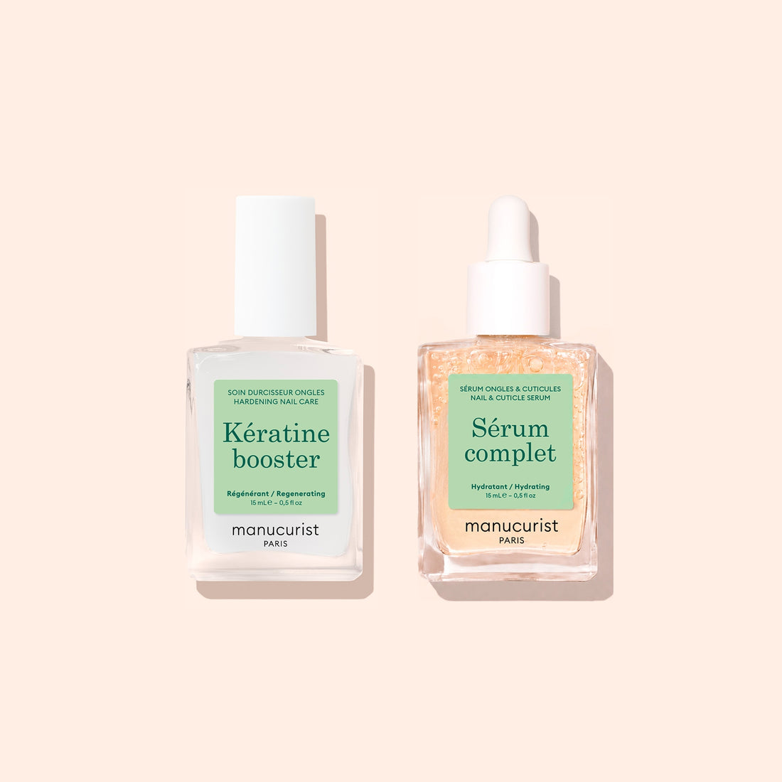Two clear glass bottles of Manucurist Basic Routine - Soft Nails products are displayed on a pale peach background. The left bottle, labeled Kératine Booster, is formulated to strengthen soft nails as part of your nail care regimen. The right bottle, Sérum Complet with a dropper cap, contains a potent nail strengthening serum. Both products are by Manucurist.