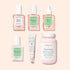 Six Manucurist Basic Routine - Damaged Nails products—including nail polishes, a serum dropper, a tube, and a bottle of supplements—are artfully arranged on a soft pink background with pastel labels, perfect for strengthening brittle nails and repairing damaged nails.