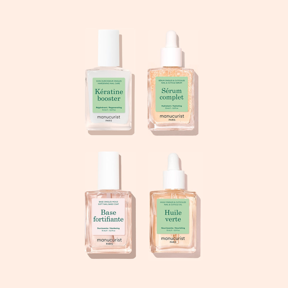 Four bottles from the Manucurist Basic Routine - Soft Nails collection are arranged in a grid on a pale pink background, each featuring a white cap or dropper and French labels accented in green or blue—ideal additions to your nail care routine, especially if you need a strengthening serum for soft nails.