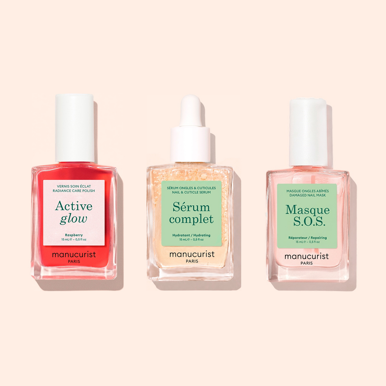 Three manicure bottles from Manucurist’s Basic Routine - Sensitive Nails—each formulated for advanced nail care—are displayed side by side on a pale peach background. This collection, crafted specifically for sensitive nails, offers everything from a hydrating polish to nourishing treatments, making it ideal for revitalizing nails and maintaining healthy hands.
