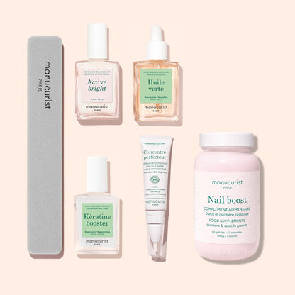The Ultimate Routine - Yellow Nails by Manucurist, featuring five essential nail care products—a nail file, nail polishes, serum, cream, and a jar of supplements—is arranged neatly on a pale pink background to elevate your nail care routine.