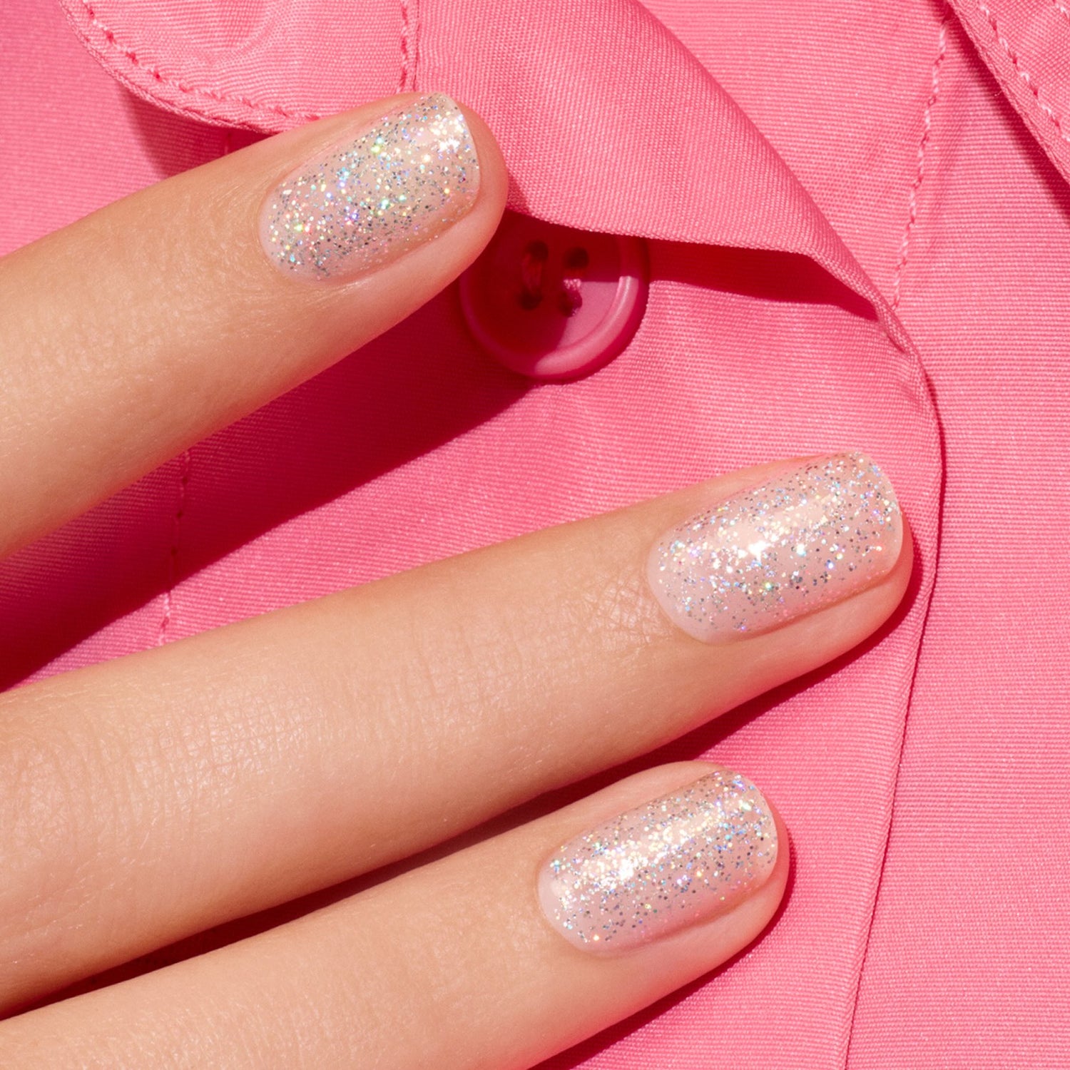 A close-up of a hand with short nails painted in Manucurist&