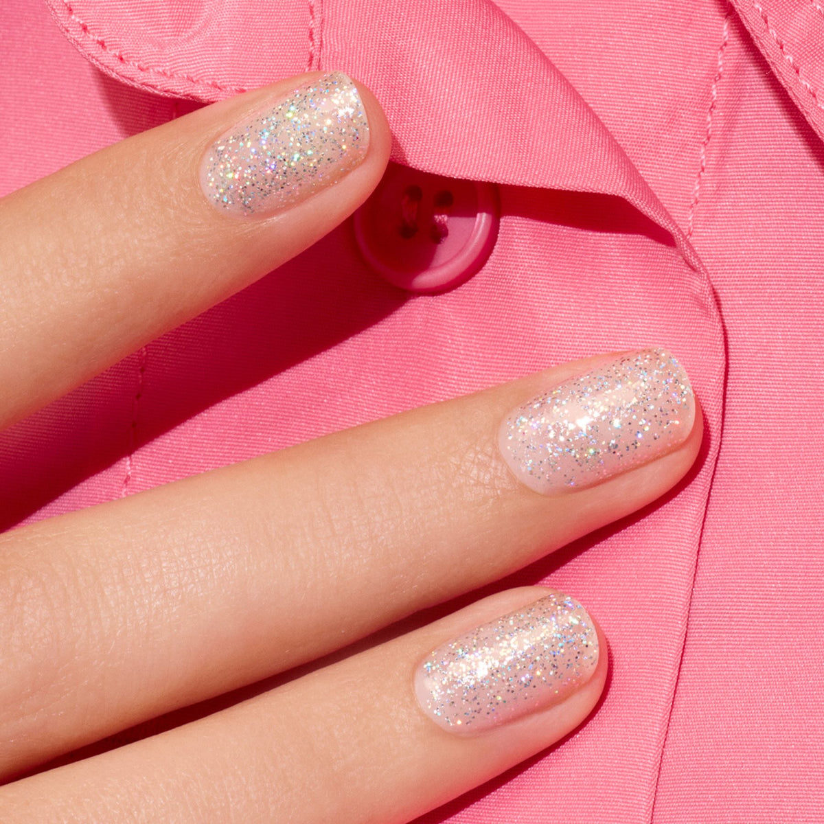 A close-up of a hand with short nails painted in Manucurist&