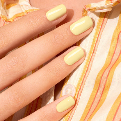 A hand with neatly manicured nails painted in Manucurist&