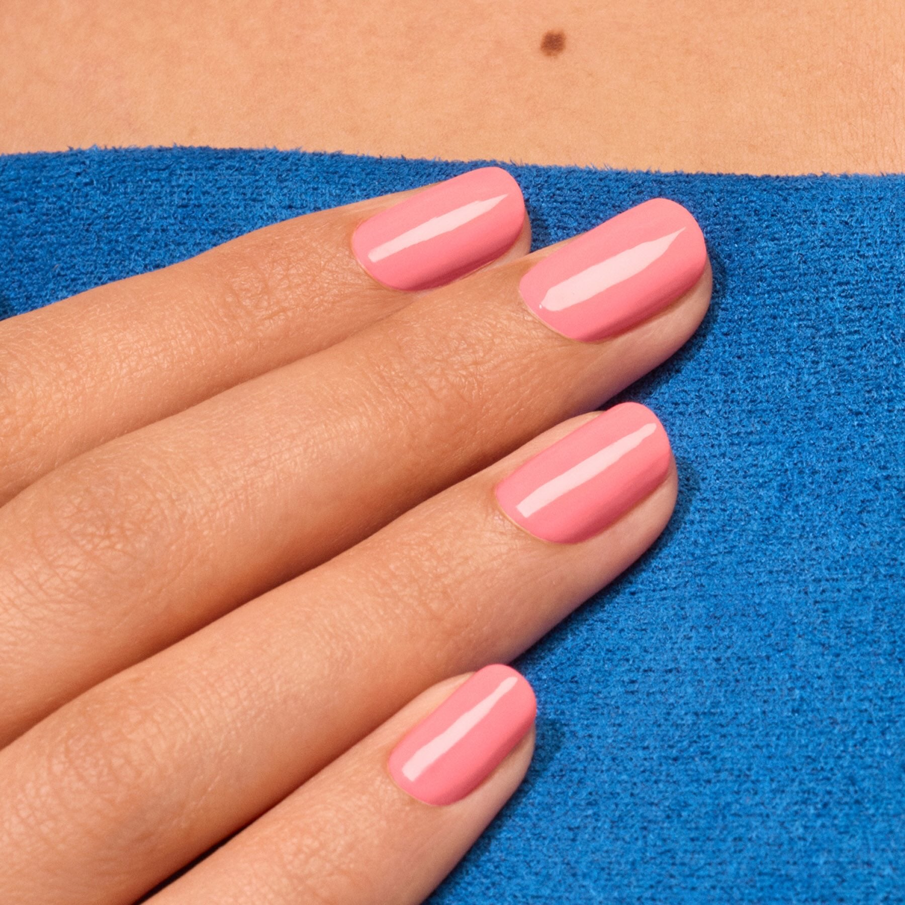 A hand with neatly manicured nails, painted in Manucurist&