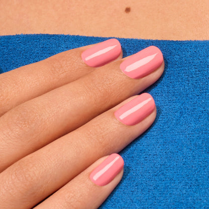 A hand with neatly manicured nails, painted in Manucurist&