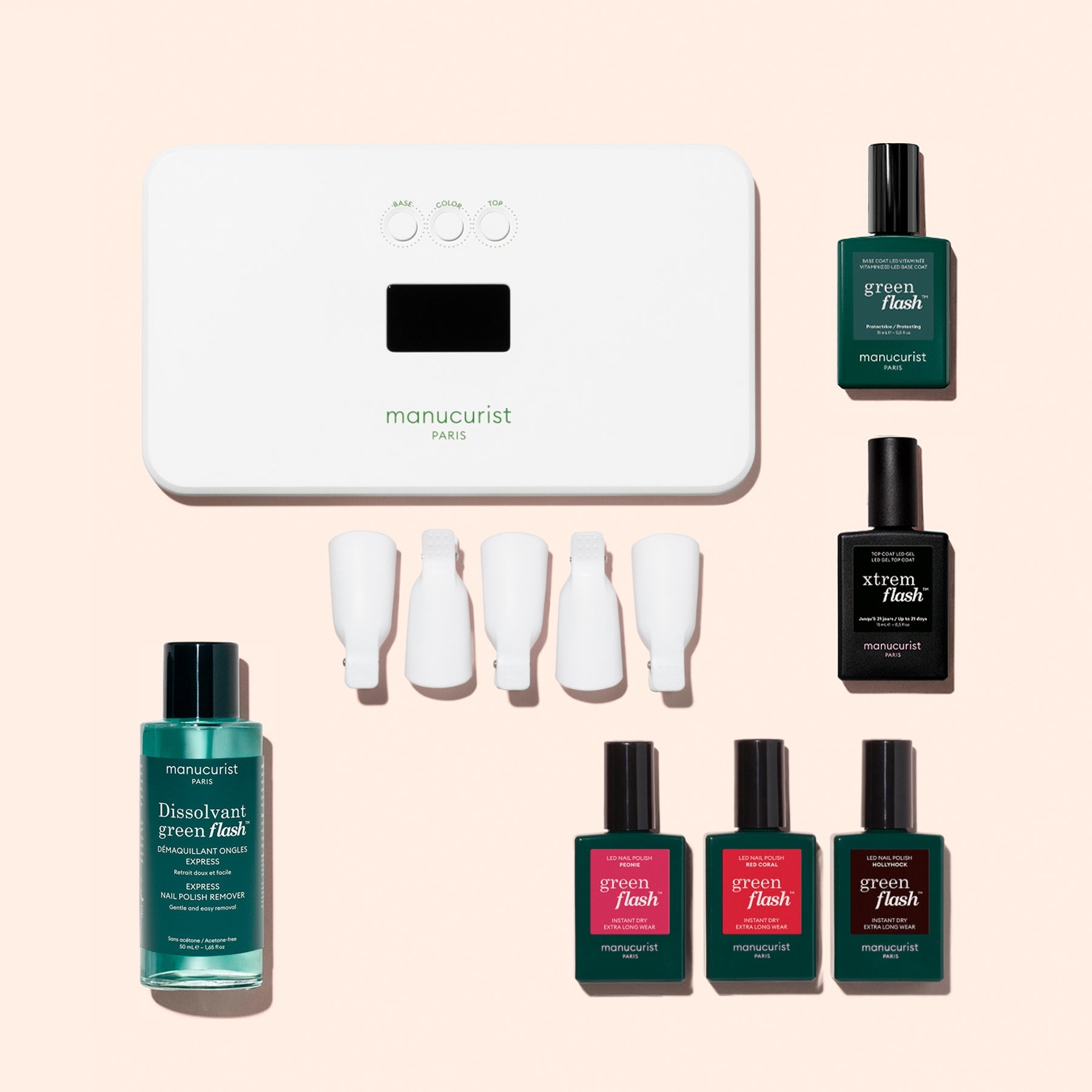 The Manucurist Starter Kit features an LED lamp, nail polish remover, four nail clips, and six bottles of nail polish in assorted colors on a light pink background—everything you need for a gorgeous, long-lasting manicure. This complete gel polish kit also includes a vitaminized base coat to help keep your nails healthy and strong.