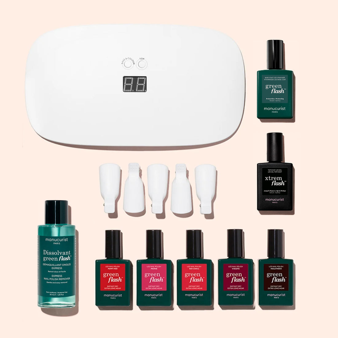 Introducing the Manucurist Super Starter Kit: this comprehensive gel polish set includes an LED lamp, nail polish remover, four nail clips, seven bottles of green-hued polish in assorted shades, and a vitamin-enriched base coat—all beautifully displayed on a light pink background for the perfect ultra-glossy manicure.