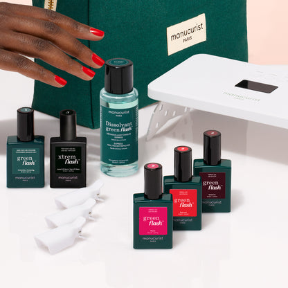 A hand with red nails is beside Manucurist&