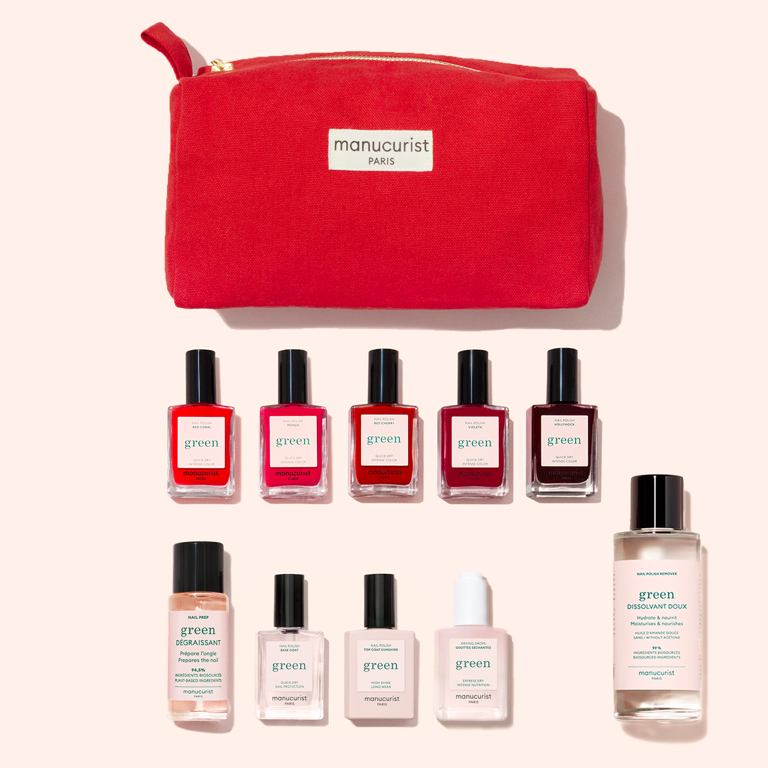The Manucurist Super Starter Kit features a red pouch displayed above ten plant-based nail polish and care products in assorted shades, all arranged neatly on a light background.