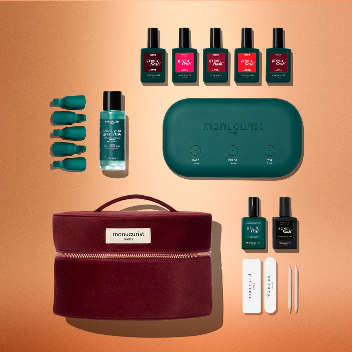Manucurist Green Flash™ Starter Kit containing a green LED lamp, five polish colors, base and top coats, remover, finger clips, files, and a burgundy carrying case for a salon-style manicure at home.