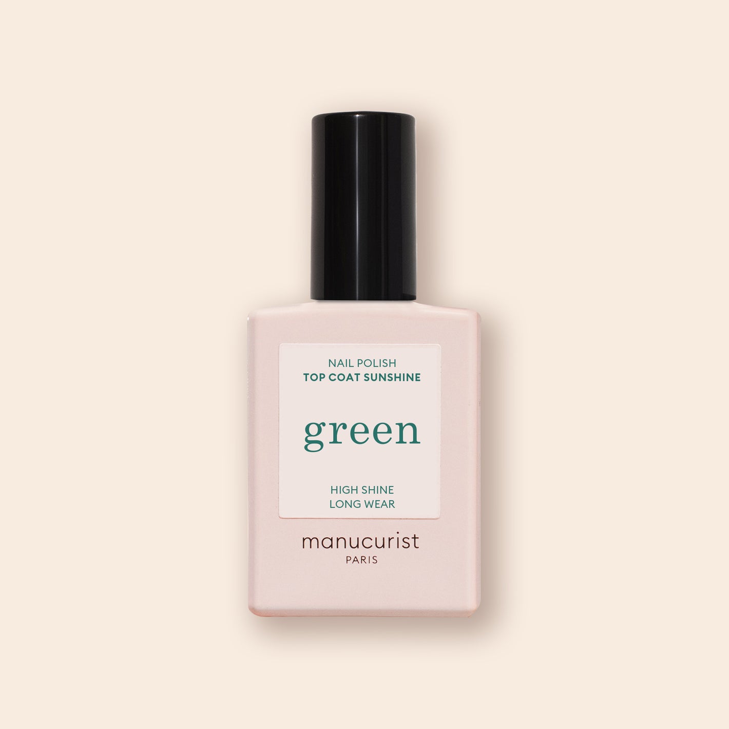 A bottle of Manucurist Sunshine Top Coat, a plant-based, high-shine, long-wear gel-effect nail polish, features a pale pink base and black cap against a beige background.