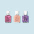 Three bottles of Manucurist’s Customisable Trio Petite Manucurist kids nail polishes with white caps on a light blue background—pink with a turtle, peach with a starfish, and purple with an owl illustration.