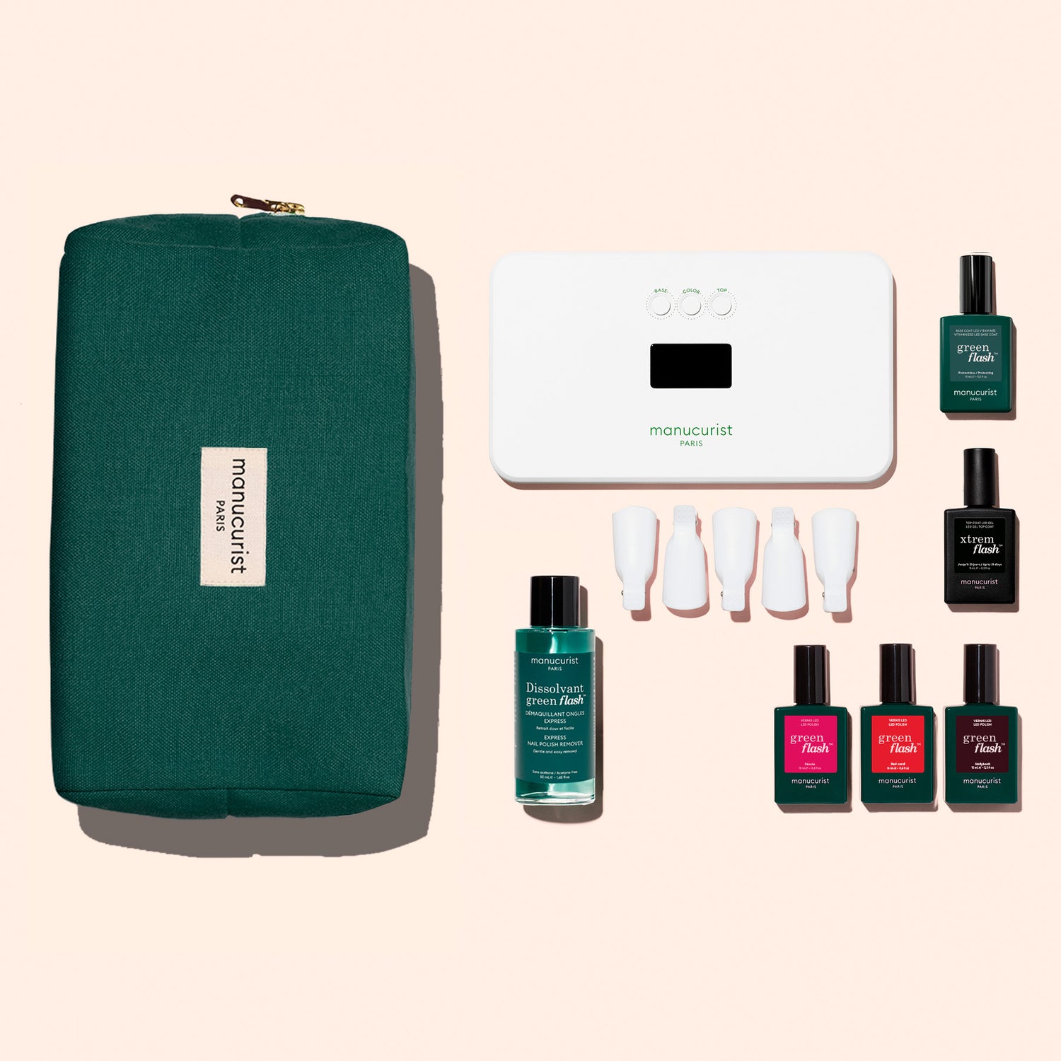 The Manucurist Starter Kit features a green pouch, white LED nail lamp, remover, four caps, and five Green Flash gel polishes for an ultra-glossy manicure—all set against a beige background.