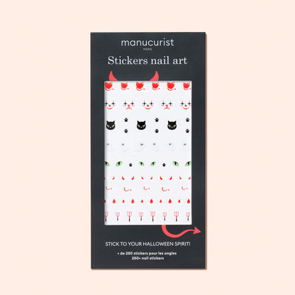 Manucurist Halloween Nail Art Stickers feature black cats, red devils, pitchforks, and skulls in a sleek black package with white text and a clear window to display the spooky designs—perfect for Halloween manicures.