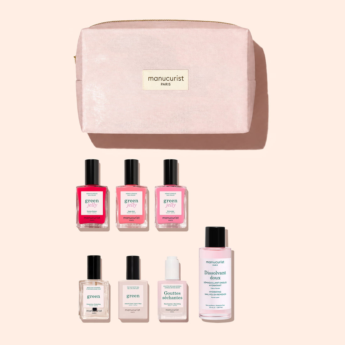 A pink Manucurist Starter Kit - Jelly Nail Polish organic cotton pouch with seven manicure products—including green essentials like gel-effect nail polish, remover, cuticle oil, and top coat—neatly arranged below, all set against a pale peach background.