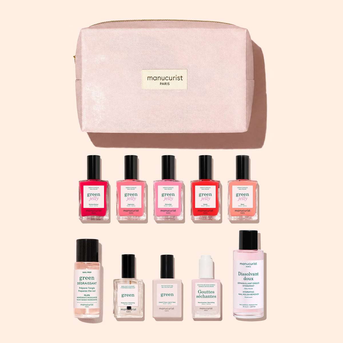 A blush pink organic cotton pouch labeled “Manucurist Paris” showcases the Super Starter Kit - Jelly Nail Polish by Manucurist, featuring ten manicure essentials—including gel-effect nail polishes, remover, oil, drops, and a clear bottle—neatly arranged in two rows against a light pink backdrop.