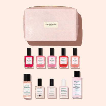A blush pink organic cotton pouch labeled “Manucurist Paris” showcases the Super Starter Kit - Jelly Nail Polish by Manucurist, featuring ten manicure essentials—including gel-effect nail polishes, remover, oil, drops, and a clear bottle—neatly arranged in two rows against a light pink backdrop.