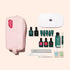 The Manucurist Addict Kit is arranged neatly on a beige background, featuring a pink pouch, an LED nail lamp, six bottles of ultra-glossy gel polish, a nail serum pen, two nail files, a cuticle pusher, and three small bottles—including the Vitaminized Base Coat.