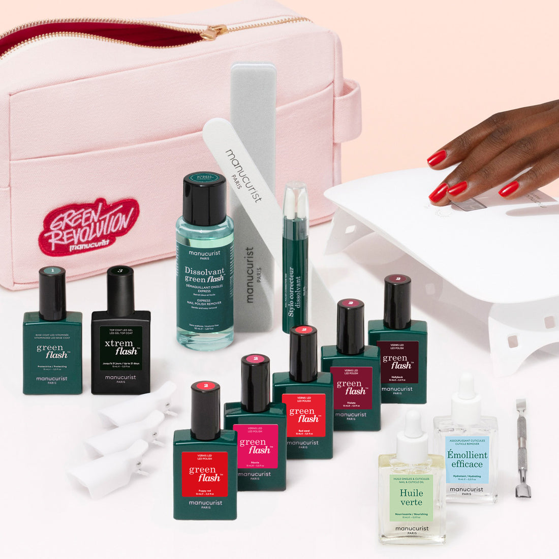 The Manucurist Super Addict Kit includes Green Flash gel polish, nail care tools, remover, vitaminized base coat, cuticle oil, nail files, a pink pouch, and creates a red ultra-glossy manicure under a nail lamp.