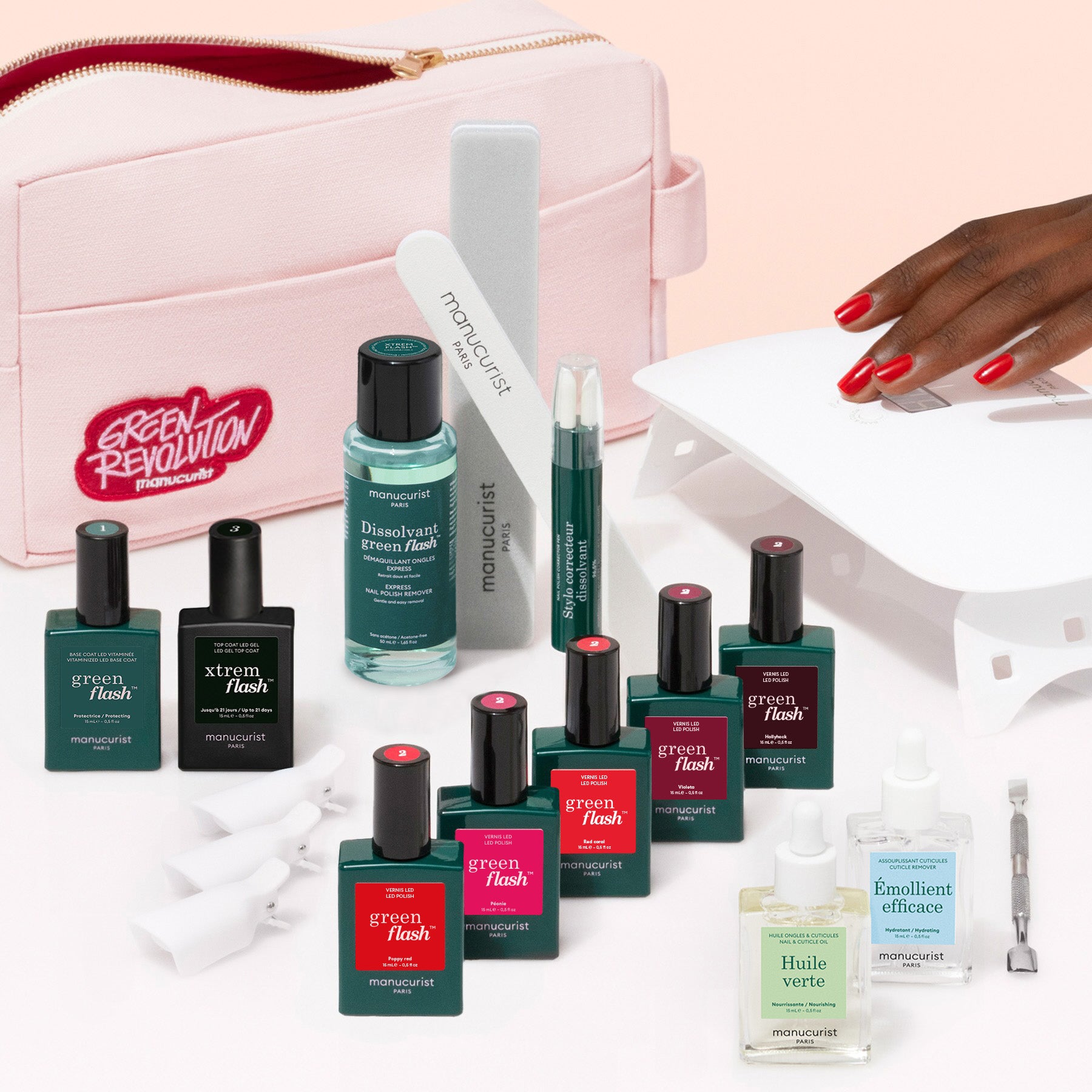 The Manucurist Super Addict Kit includes Green Flash gel polish, nail care tools, remover, vitaminized base coat, cuticle oil, nail files, a pink pouch, and creates a red ultra-glossy manicure under a nail lamp.