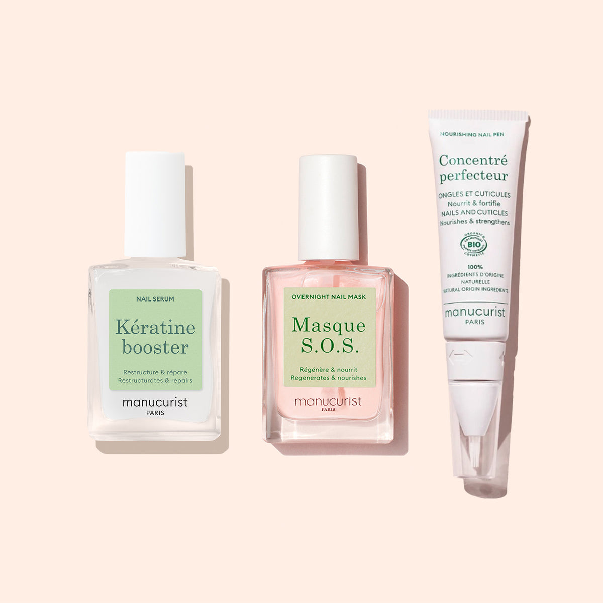 Three nail care products from Manucurist are arranged side by side: Nail Strengthening Serum in a square bottle, Masque S.O.S. overnight mask for damaged nails, and Concenté Perfecteur in a tube.