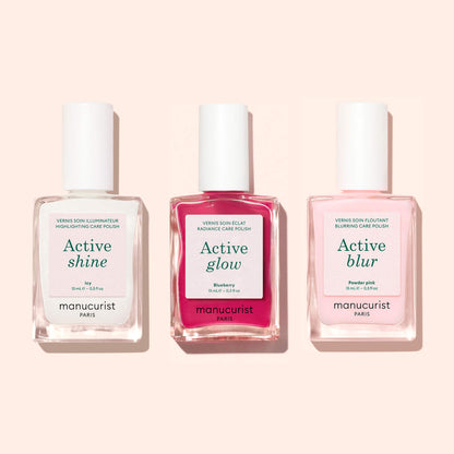 Three bottles of Manucurist Active™ Shine Icy nail polish, displayed side by side against a light pink background—perfect for anyone looking to brighten their nails with an illuminating polish as part of their nail care routine.