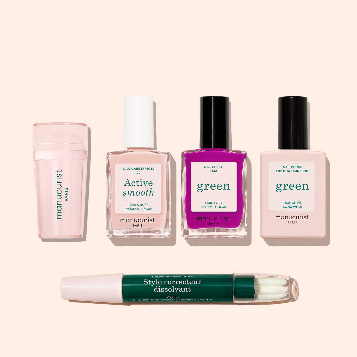The French Colour Kit features five manicure essentials on a light beige surface: a pink Mani stamper, Active Smooth bottle, two nail polishes (pink and purple), and a green-tipped Stylo correcteur dissolvant pen—ideal for French tips.