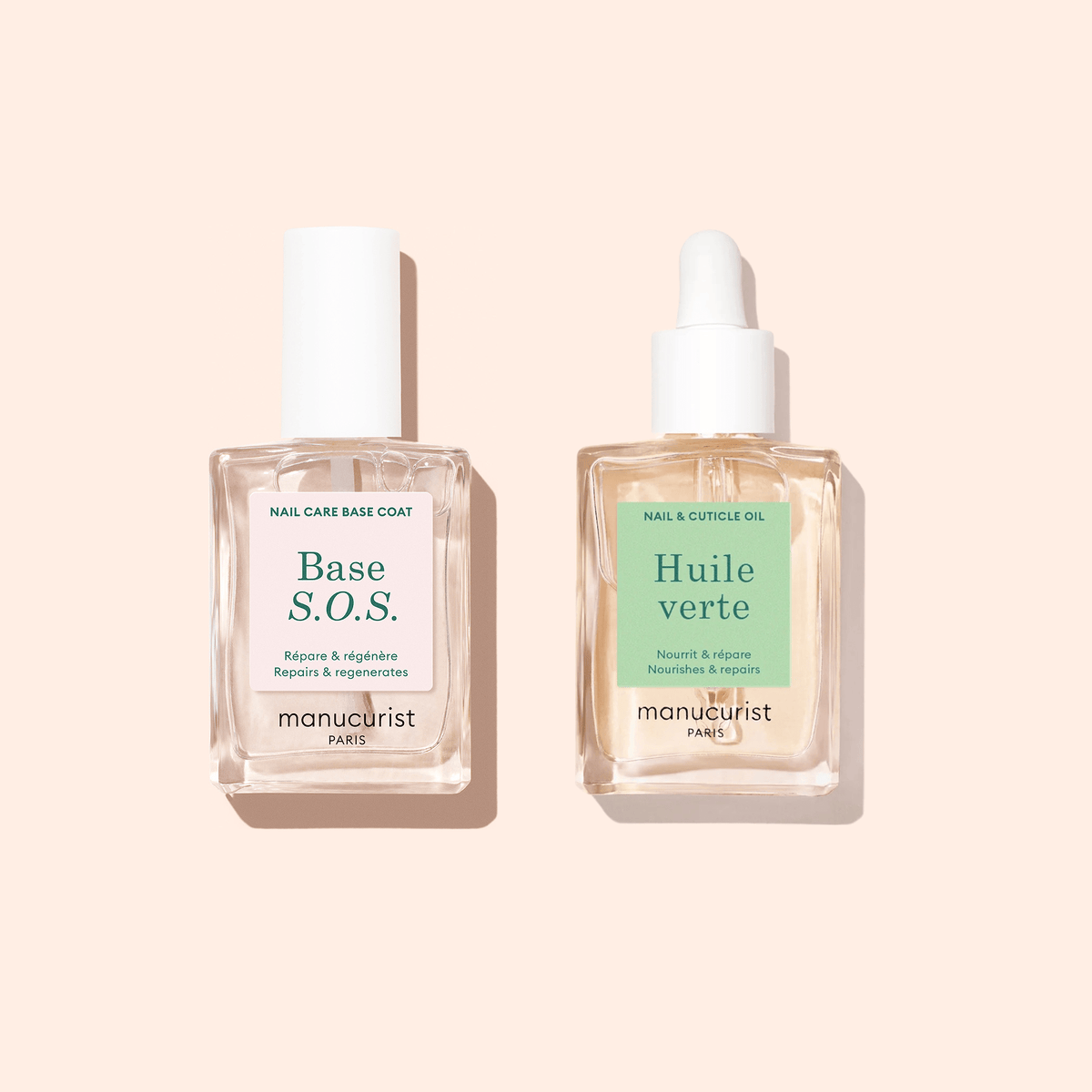 S.O.S Rescue Duo by Manucurist features two glass bottles—a Base S.O.S. with a white cap and Huile Verte with a dropper cap—nourishing nail treatments for damaged nails, pictured on a light peach background.