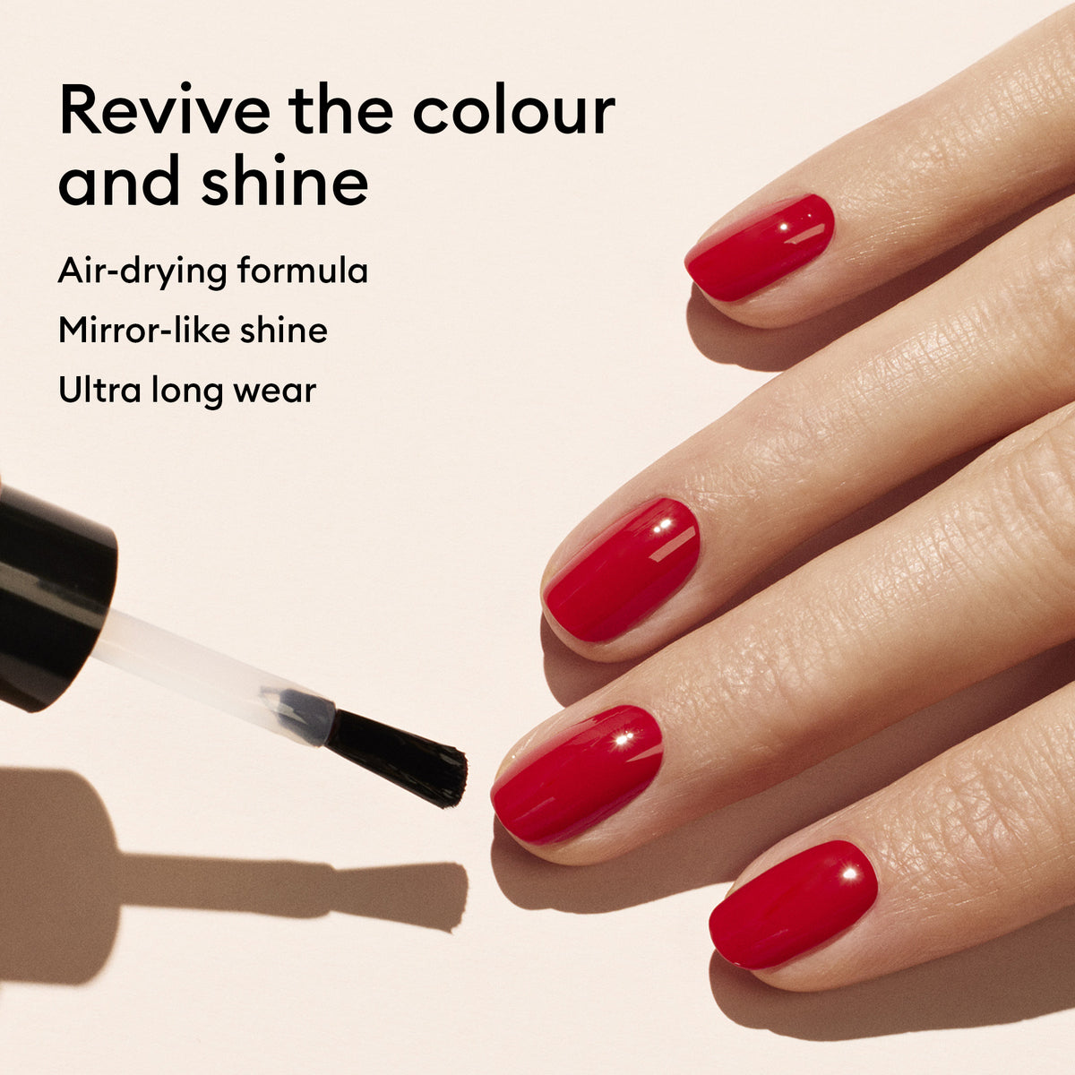 A hand with a fresh manicure, nails painted bright red. A brush applies Manucurist Colour Refresher for easy touch-ups. Text reads: Revive colour and shine. Air-drying, mirror-like extreme shine. Ultra long wear.