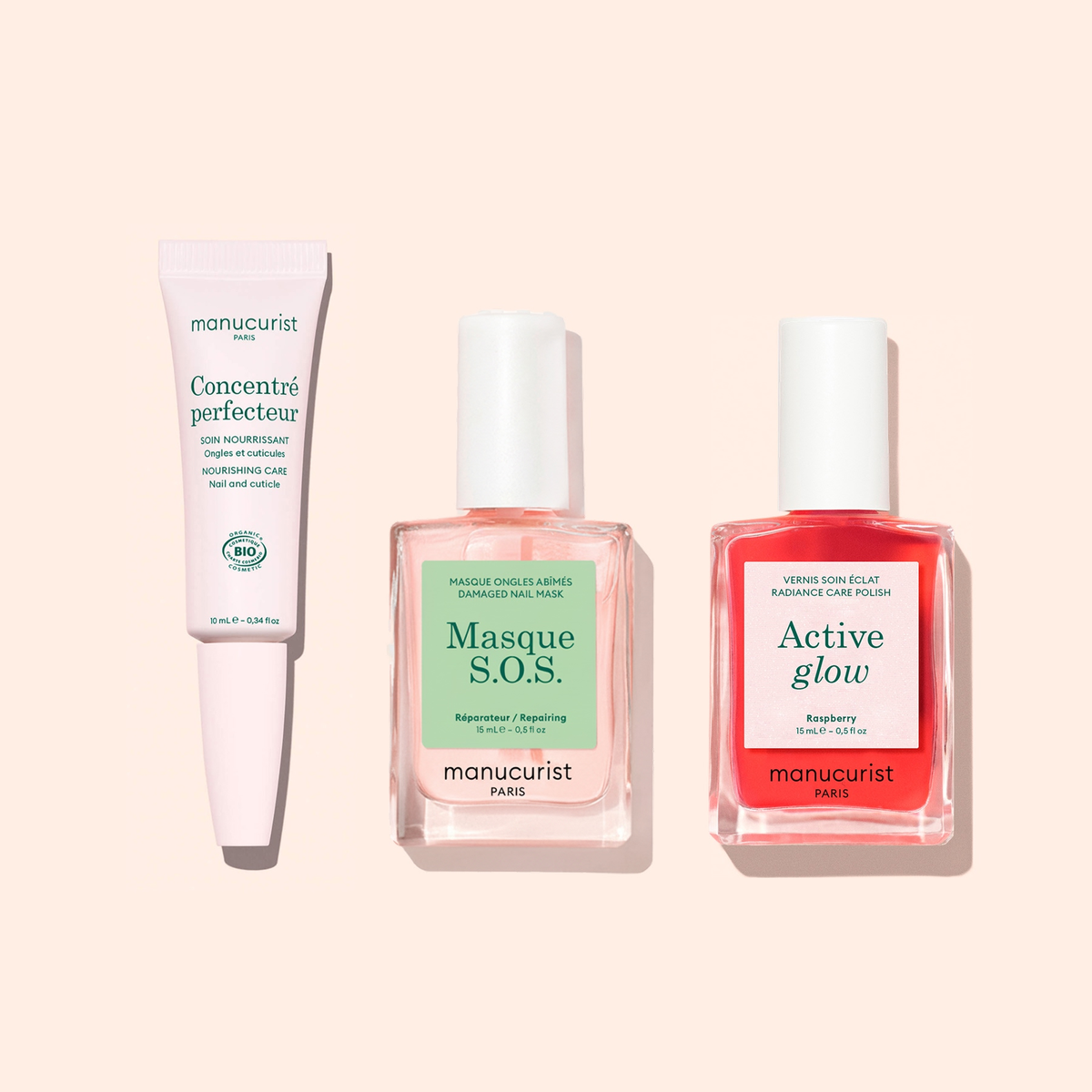 Manucurist’s Strong Glow Trio on a light pink background: includes a cuticle care pen, a pink overnight nail mask, and bright red polish—ideal for restoring damaged nails.