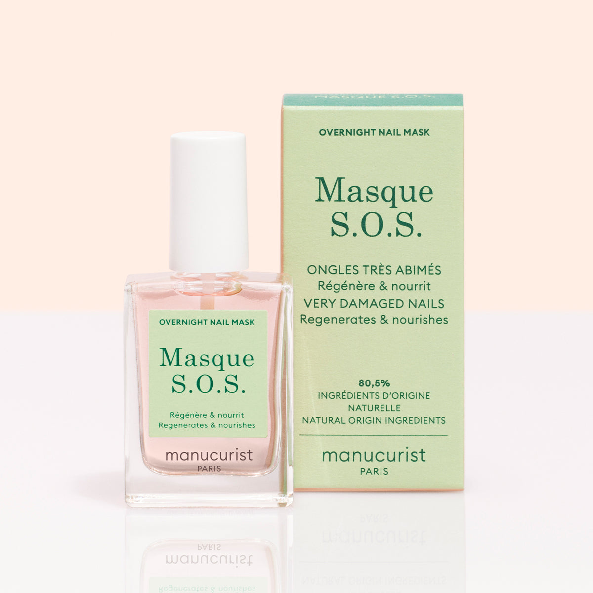 A bottle of S.O.S. Nail Mask by Manucurist sits beside its light green box, both displaying text about natural ingredients and benefits for nail regeneration and caring for very damaged nails.