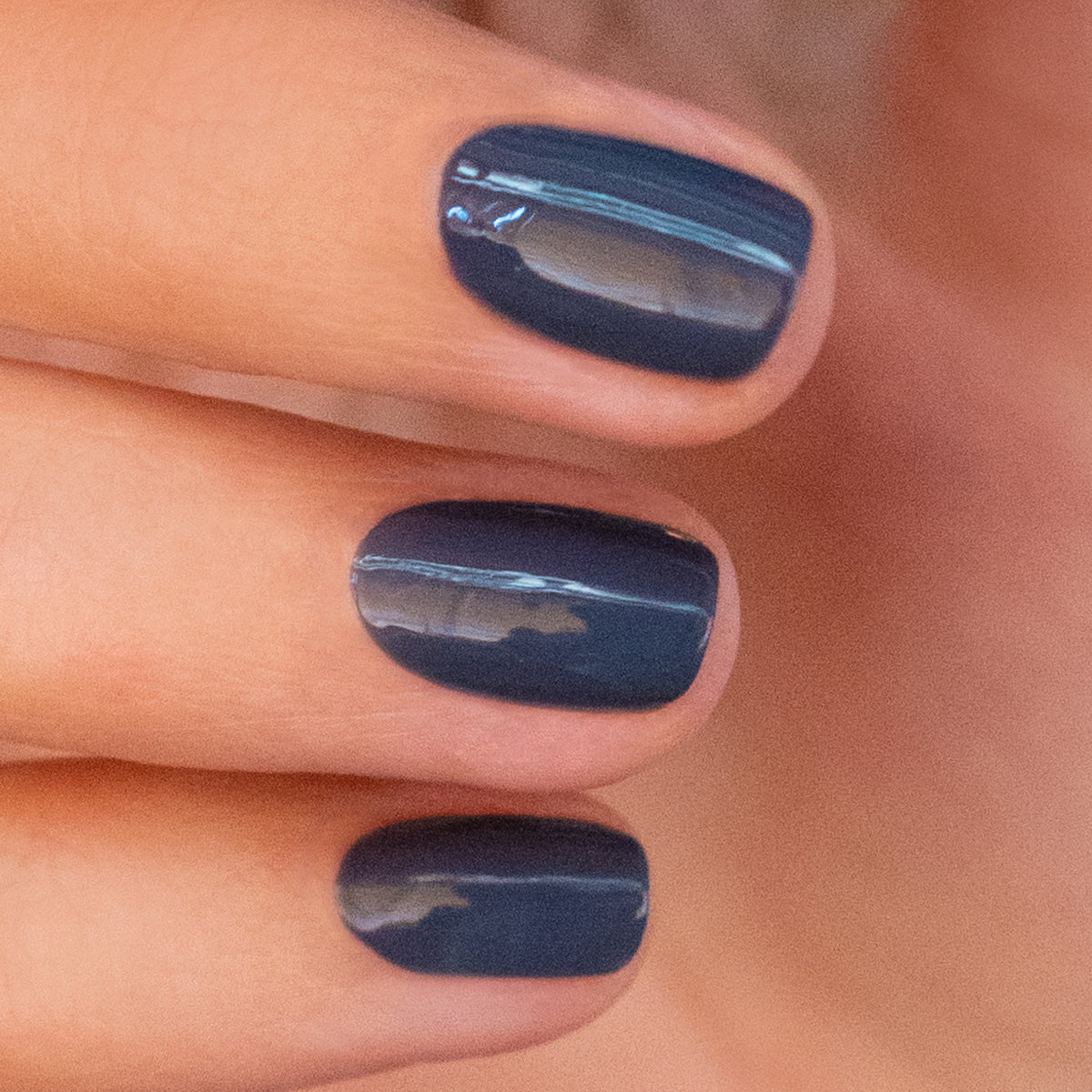 A close-up of three neatly manicured nails painted with Manucurist&
