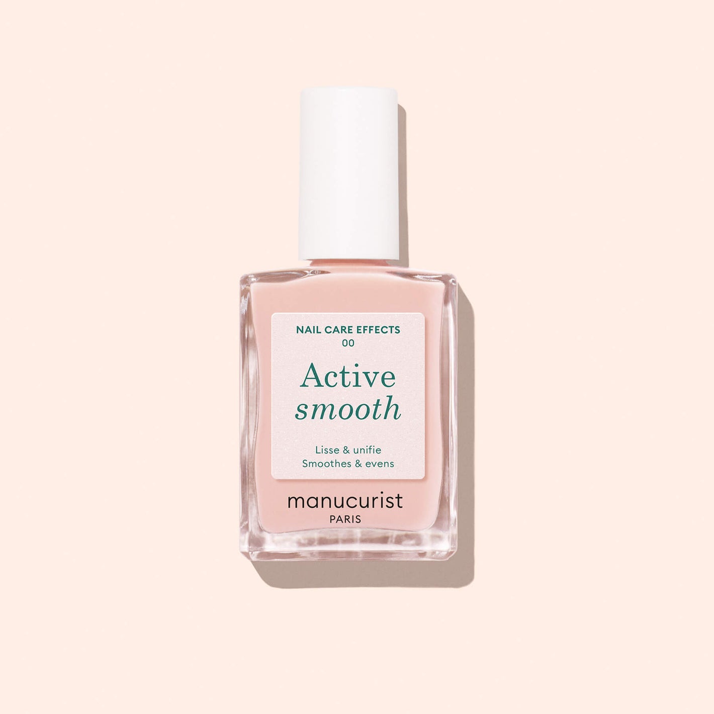 A bottle of Active Smooth 00 (OLD) plant-based nail treatment with a white cap and light pink liquid sits on a pale pink background. The label highlights its nail care and smoothing effects.