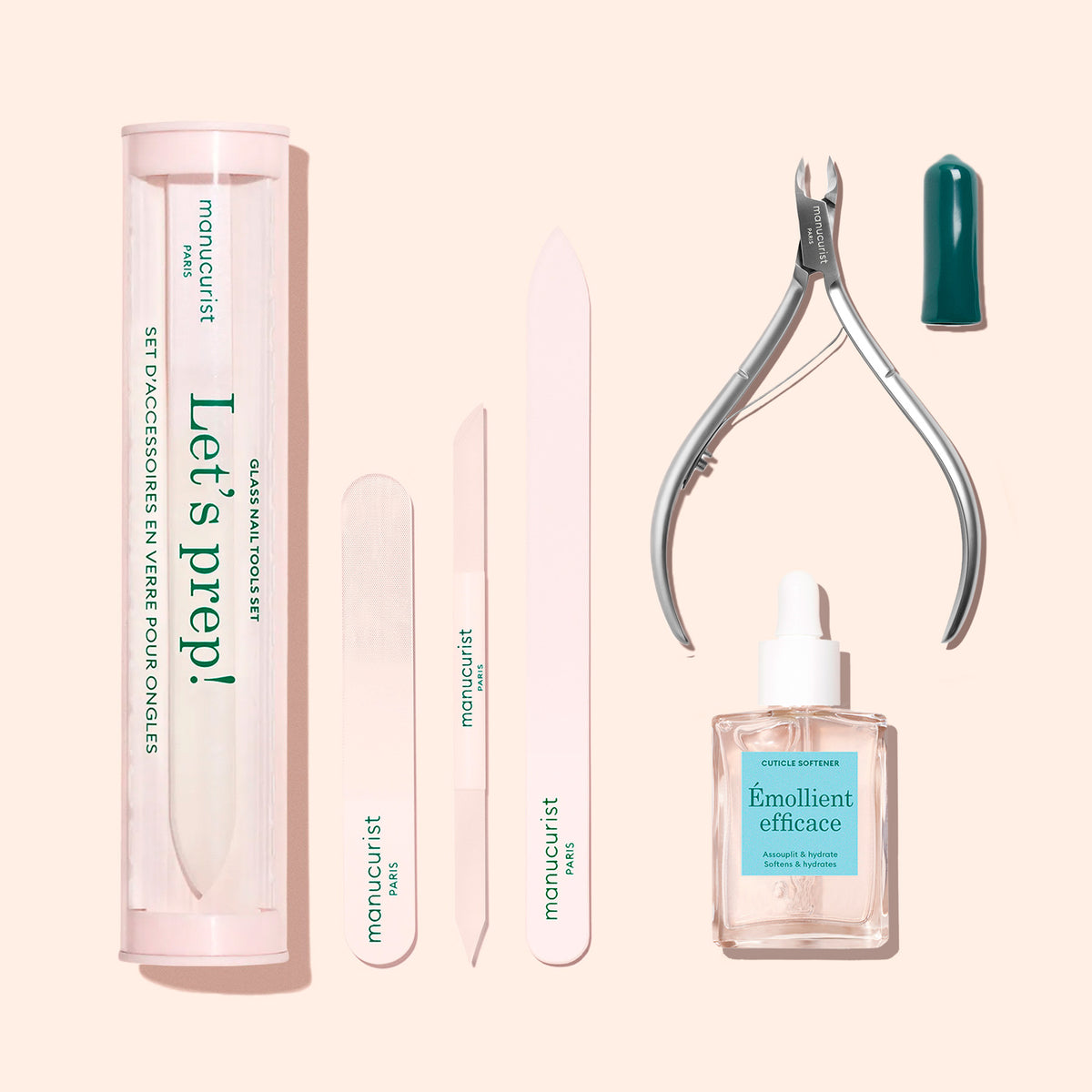 The Manucurist Nail Prep Set features an emery board, buffer, cuticle pusher, cuticle cutters, cuticle remover bottle, and a cylindrical storage case, all neatly arranged on a beige background.