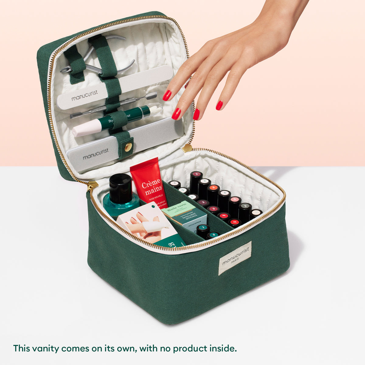 An open green Manucurist Vanity Pouch with a cream interior displays manicure tools; a hand with red nails reaches for an item inside. Text notes this stylish Vanity Pouch by Manucurist is sold empty.