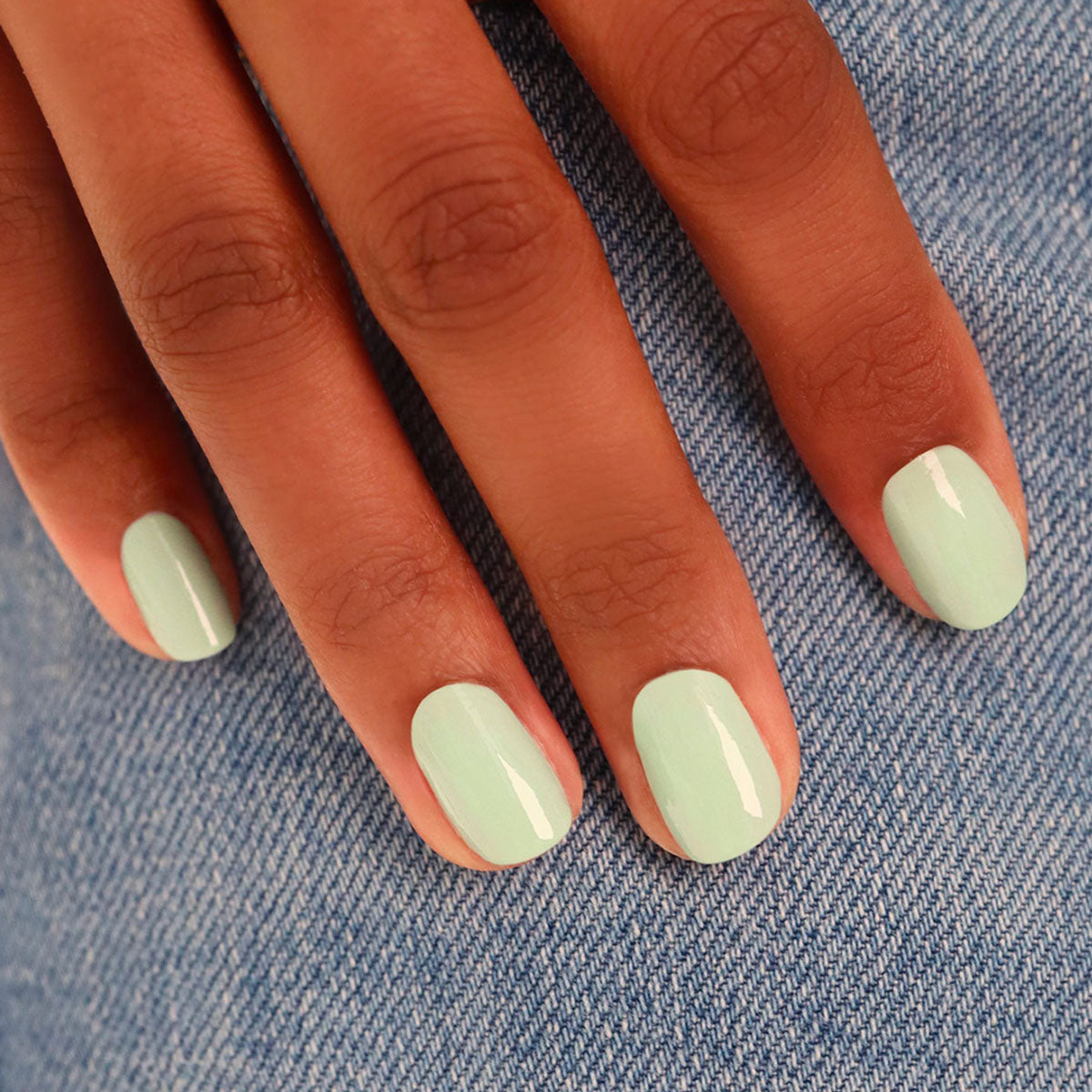 A hand with neatly manicured nails painted in Manucurist&