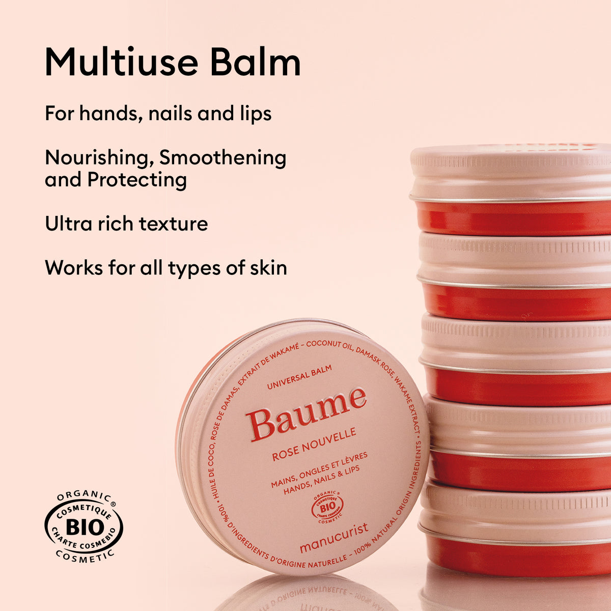 A stack of round red and white balm containers sits on a beige background. The front container, labeled Manucurist, is the Natural Nourishing Balm - Cosmos Organic, a multipurpose balm to soothe and repair hands, nails, and lips.