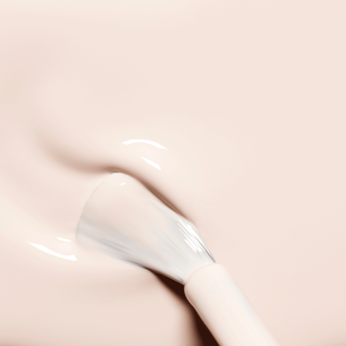 A close-up shows the Manucurist Crème brush applying creamy, milky off-white polish onto a smooth surface. The slightly spread bristles reveal the glossy texture of this nail product.