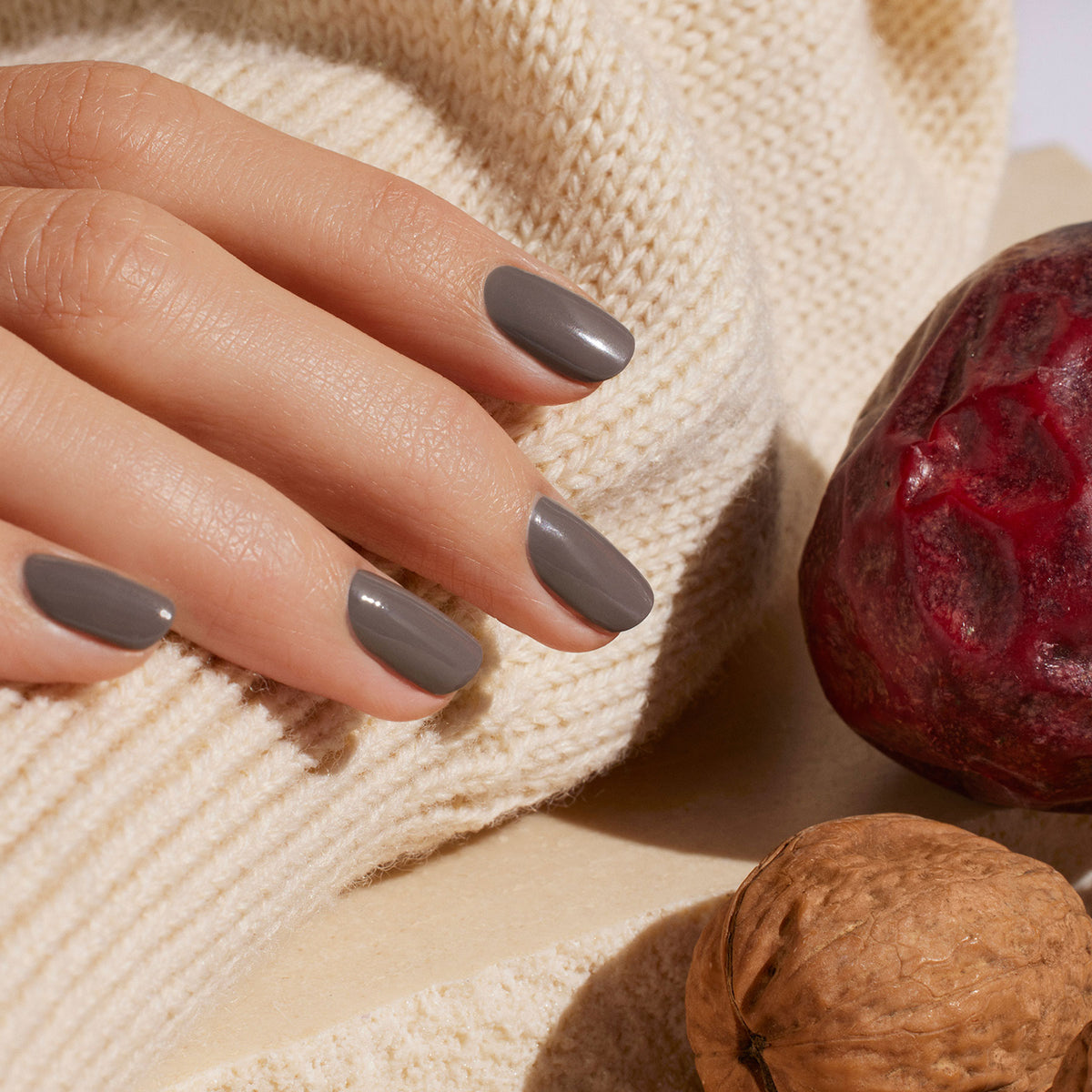 A hand with short, neatly manicured nails painted in Manucurist&