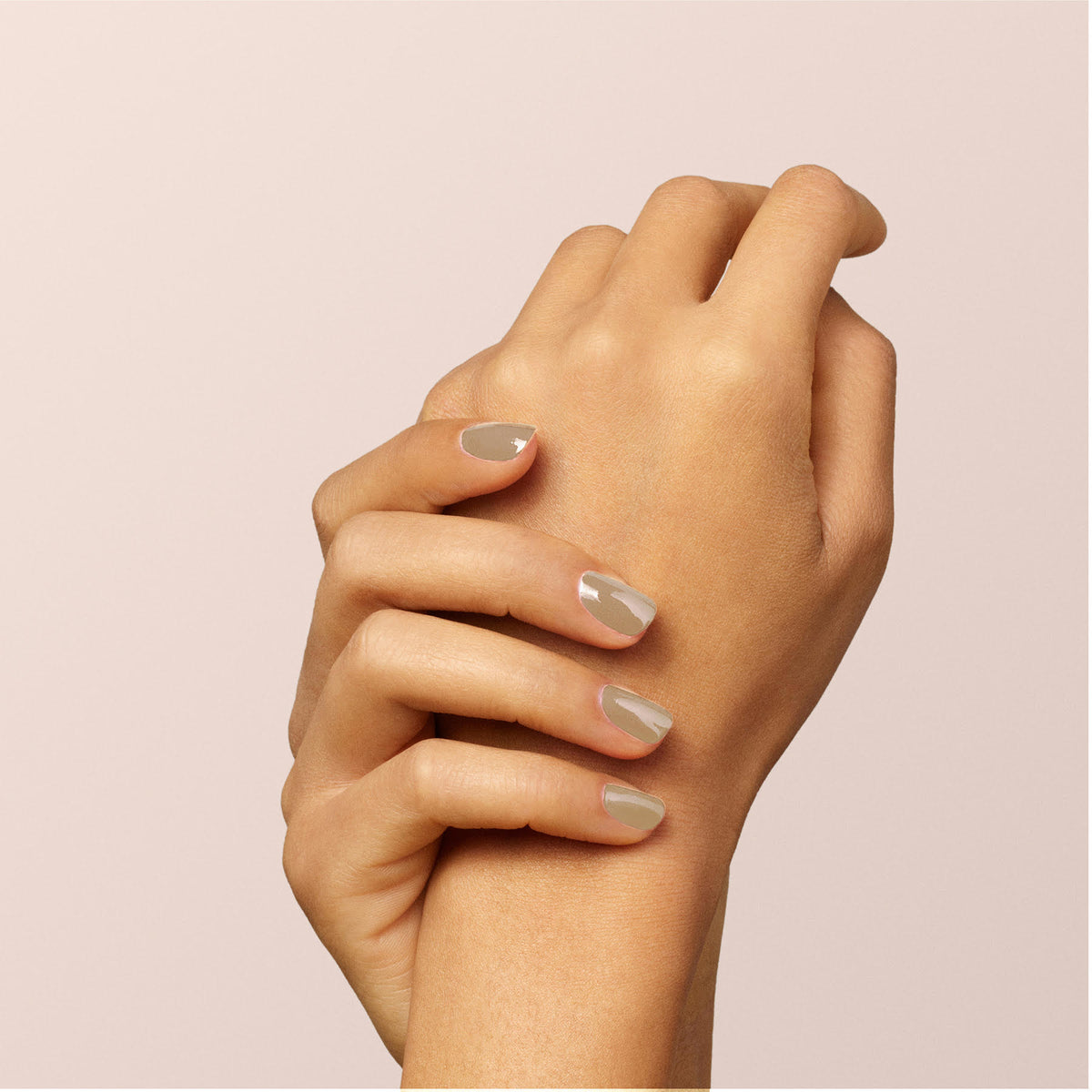 A close-up of two hands, one gently holding the other&