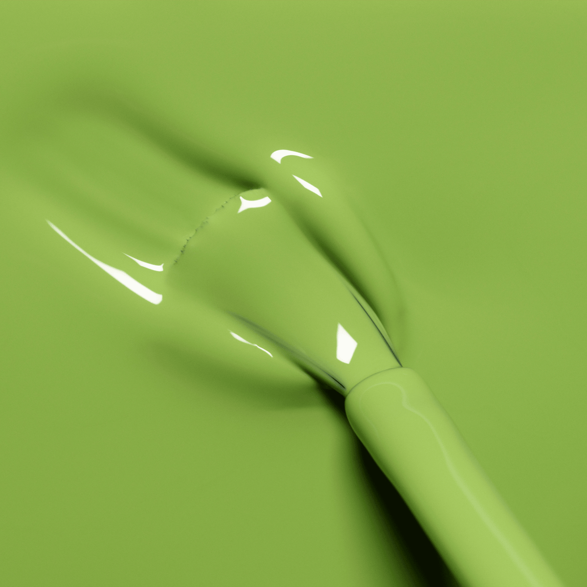 A close-up of a nail polish brush spreading glossy Manucurist Sweet Pea Green Flash gel polish on a smooth surface, creating a shiny, even layer.