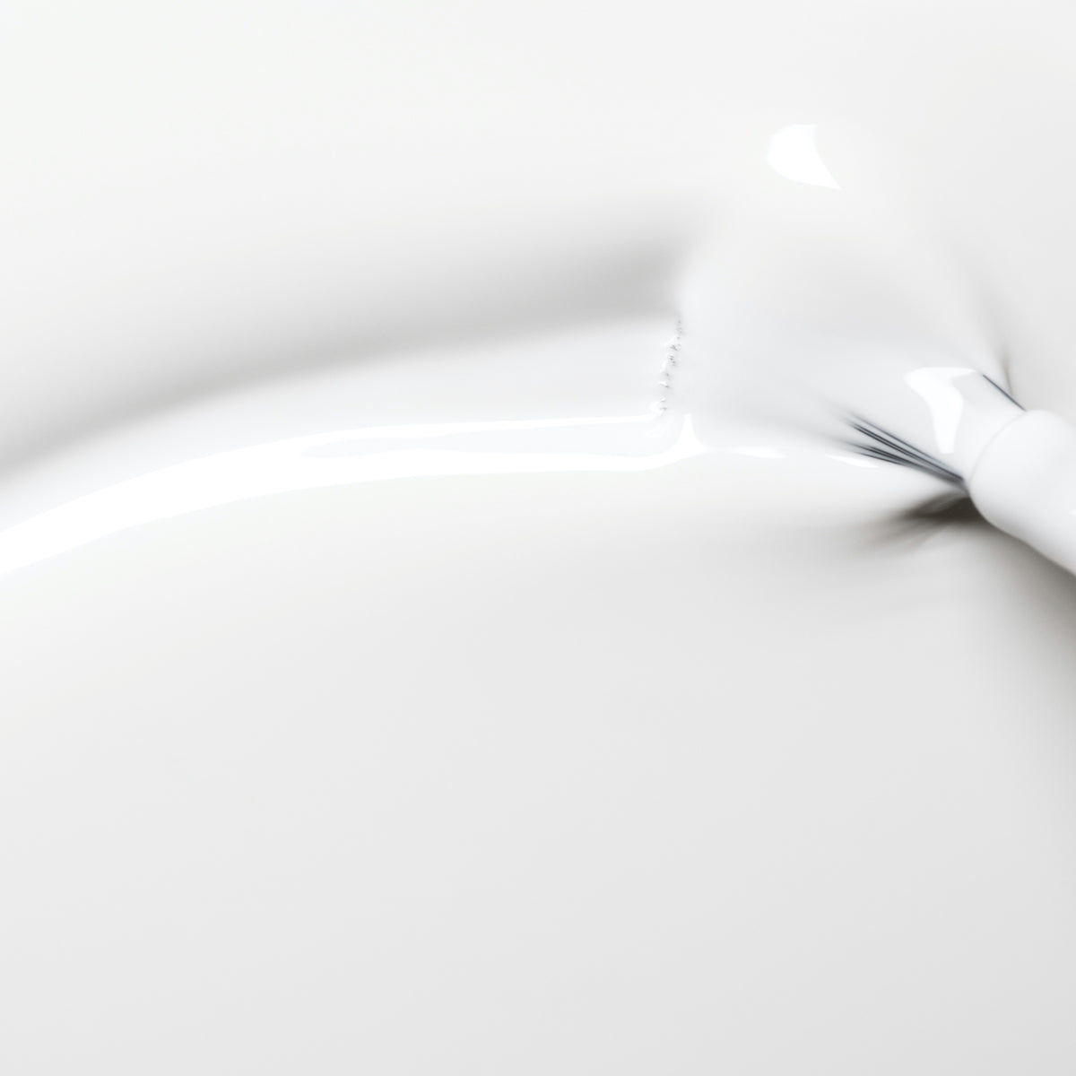 Snow by Manucurist features a smooth, glossy white surface with a soft, flowing texture and subtle shadows, reminiscent of pure white nail polish or creamy liquid gently spreading out.