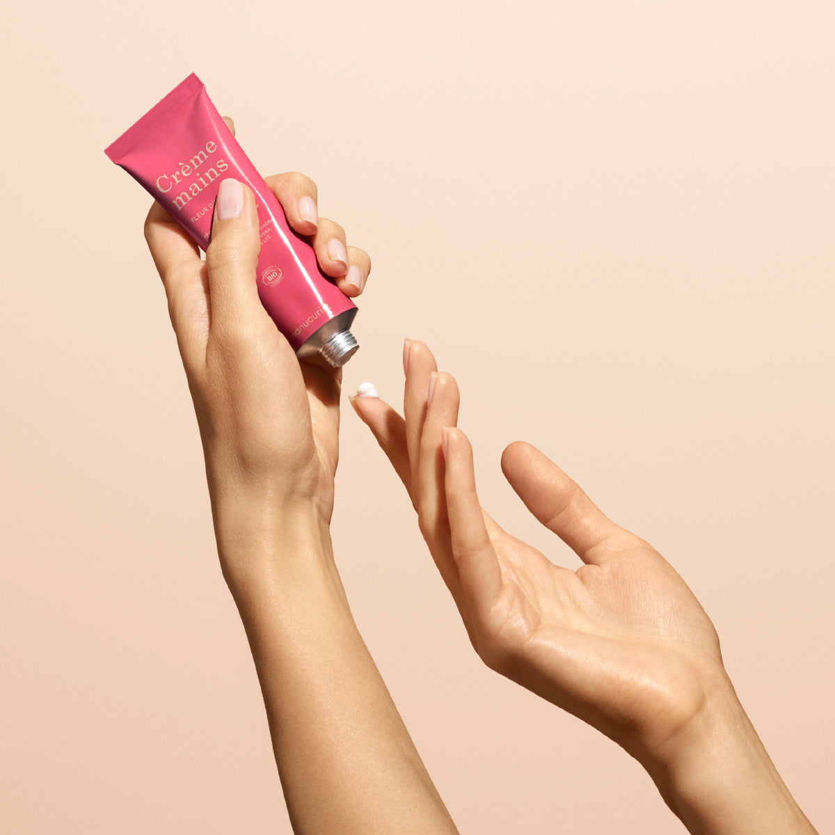 A person dispenses a small amount of Manucurist Fleur d&