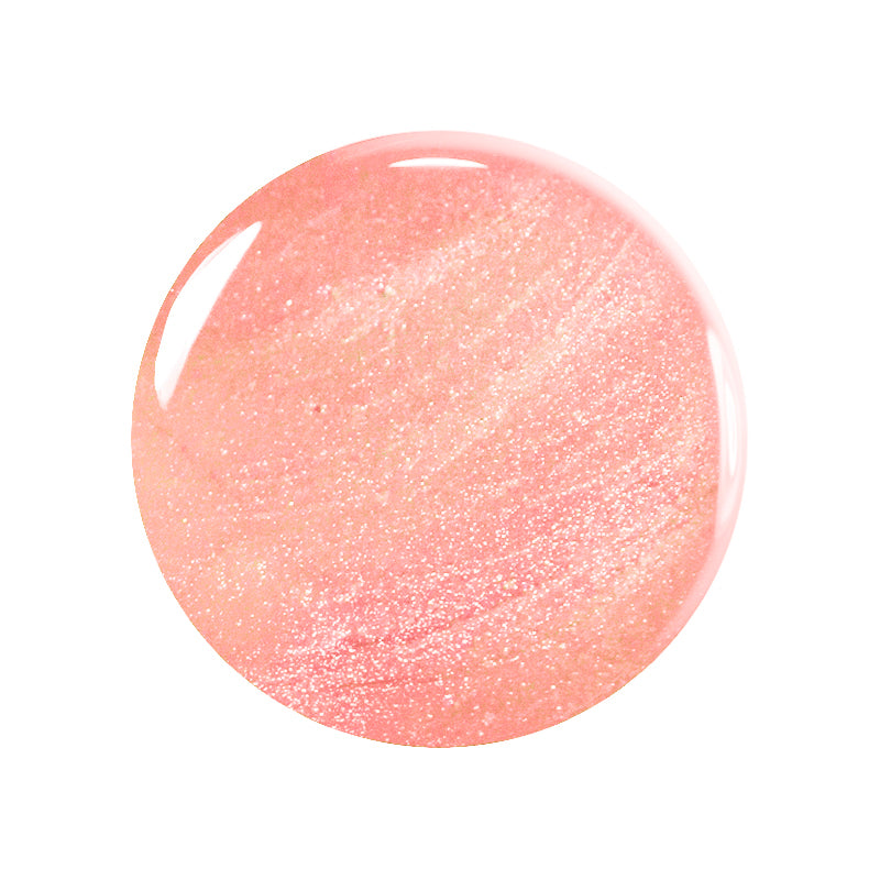 A round swatch of Manucurist’s Betty Scarlett Stella set nail polish in glossy, shimmery peach-pink with iridescent glitter, shown on a white background. A non-toxic option for everyday glam.
